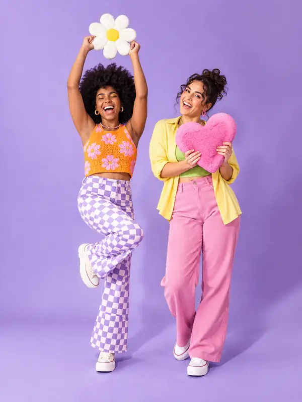 Two friends posing together in a colourful original studio photograph.